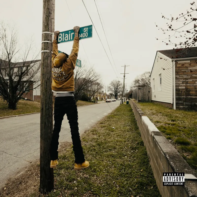 Left Me Out To Dry cover art — Luh Kiddo hanging from a Blair St sign post